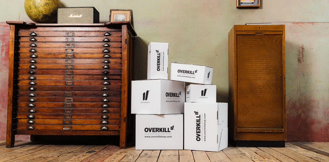  A stack of Overkill boxes next to a dresser, hinting at something exciting coming soon!