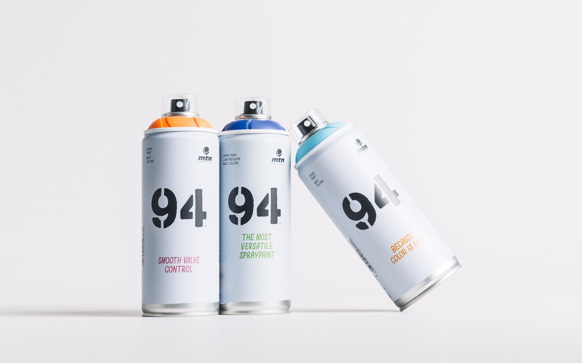 Three MTN spray cans with the number 94 on them.