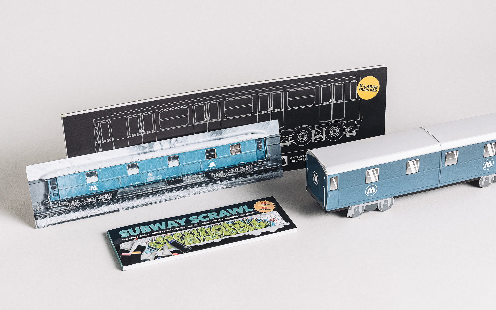 A mini train set with a book and a magazine, all in blue and white.