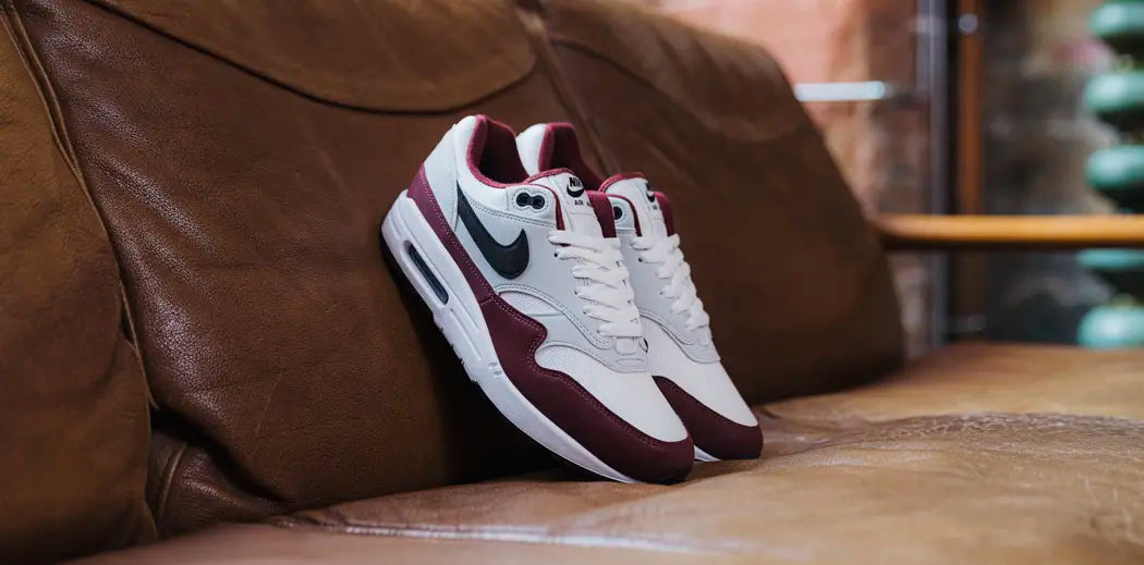  Nike Air Max 1: Classic white and black sneakers with the iconic Nike logo, perfect for any casual outfit.