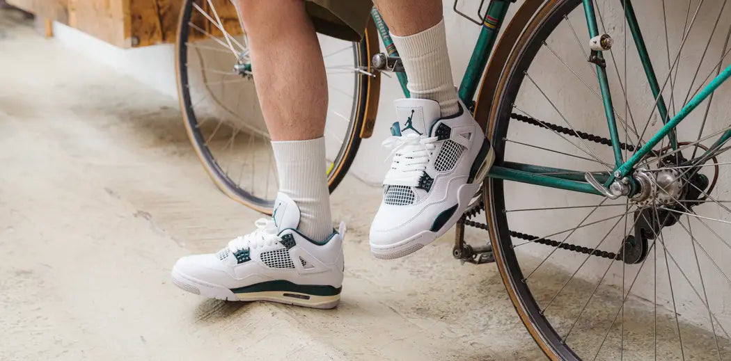 Basketball sneakers for men worn by a guy on a bike