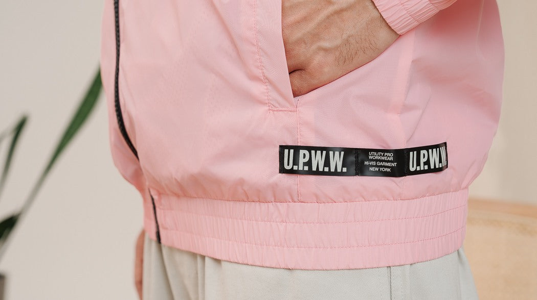 A man wearing a pink jacket by U.P.W.W.