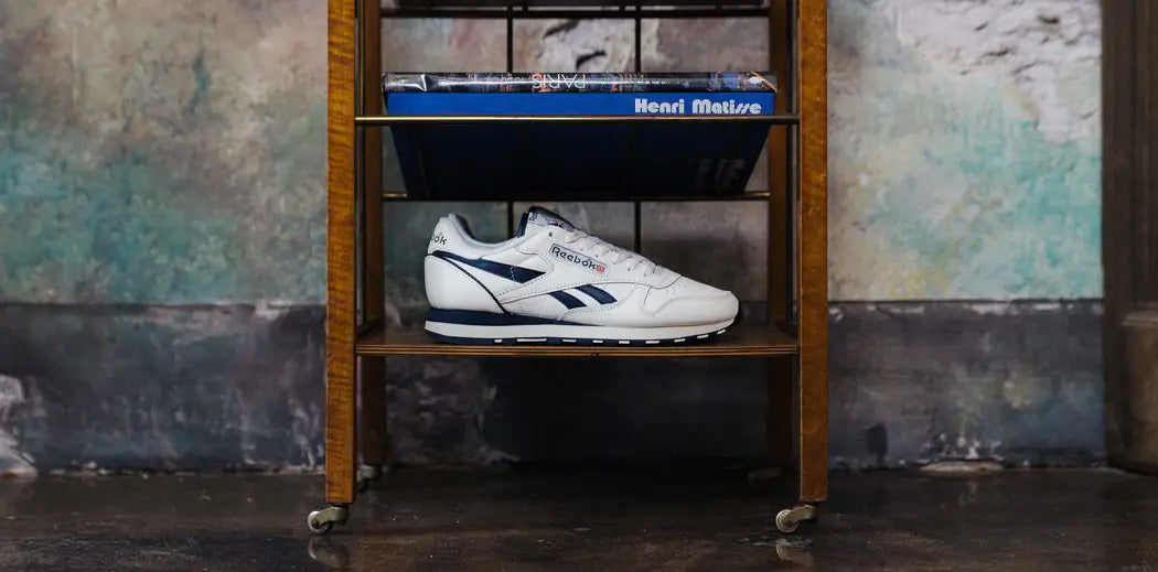 Reebok Classic Leather shoes arranged in a shelf.