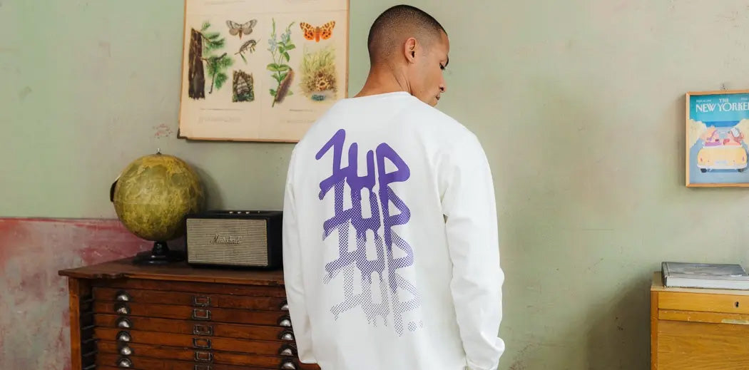 Guy wearing a sweater by 1UP showcasing the backprint.