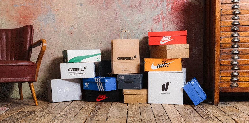A wooden cabinet and chair, surrounded by Overkill apparel and sneaker boxes.